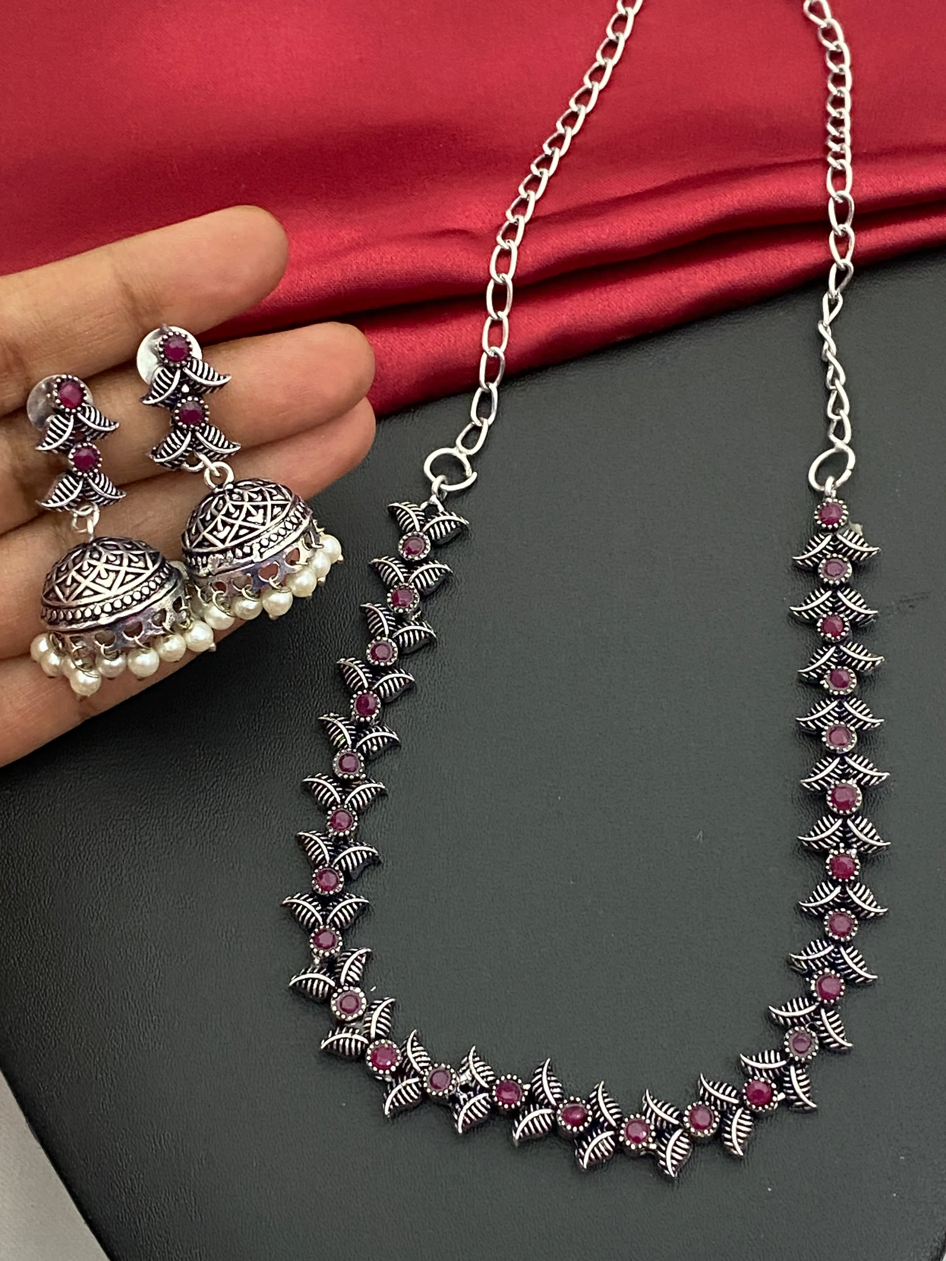 Fascinating Silver Oxidized Ruby Stone Studded Vintage Design Sleek Necklace Set With Jhumka Earrings