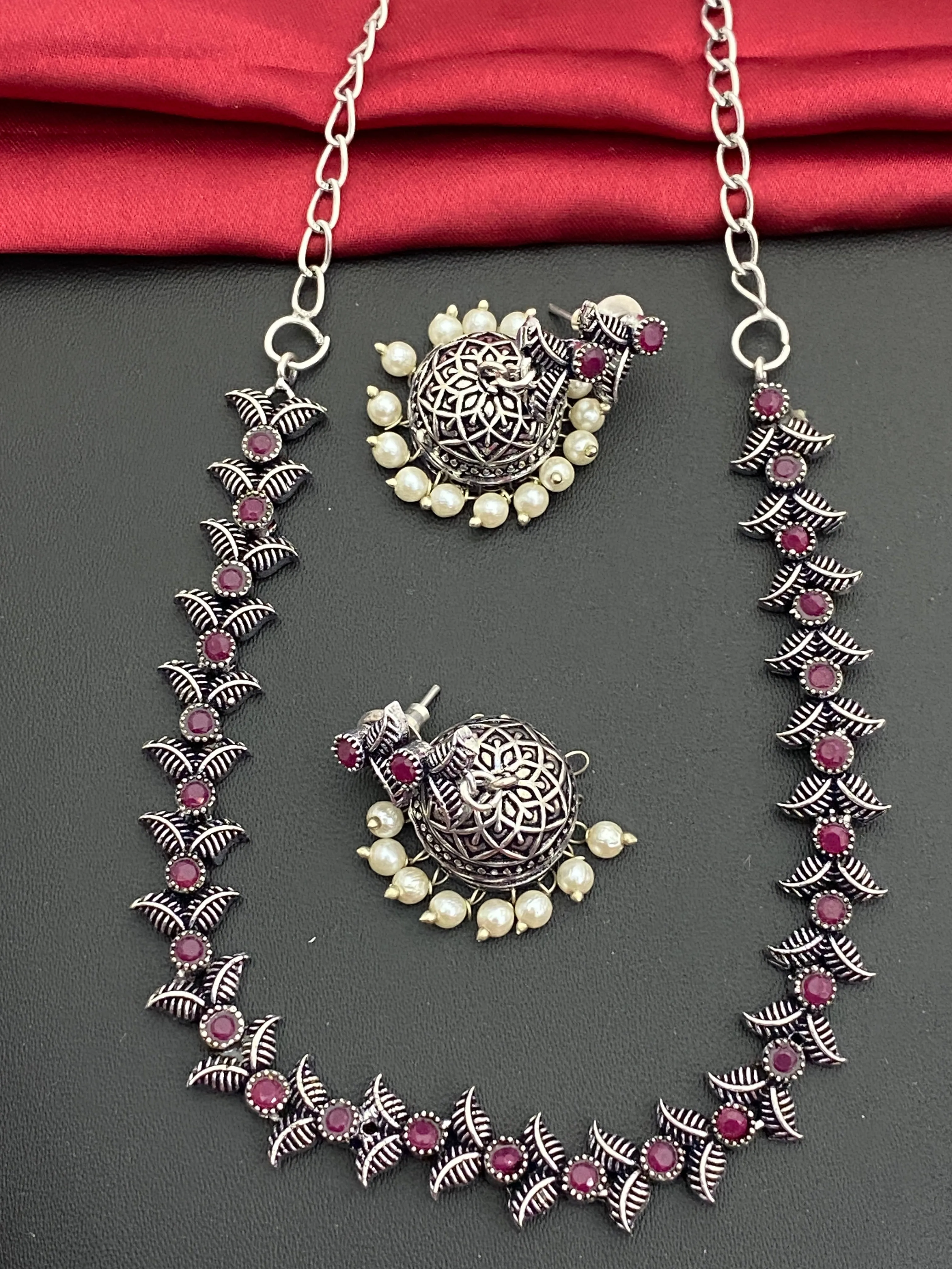 Fascinating Silver Oxidized Ruby Stone Studded Vintage Design Sleek Necklace Set With Jhumka Earrings